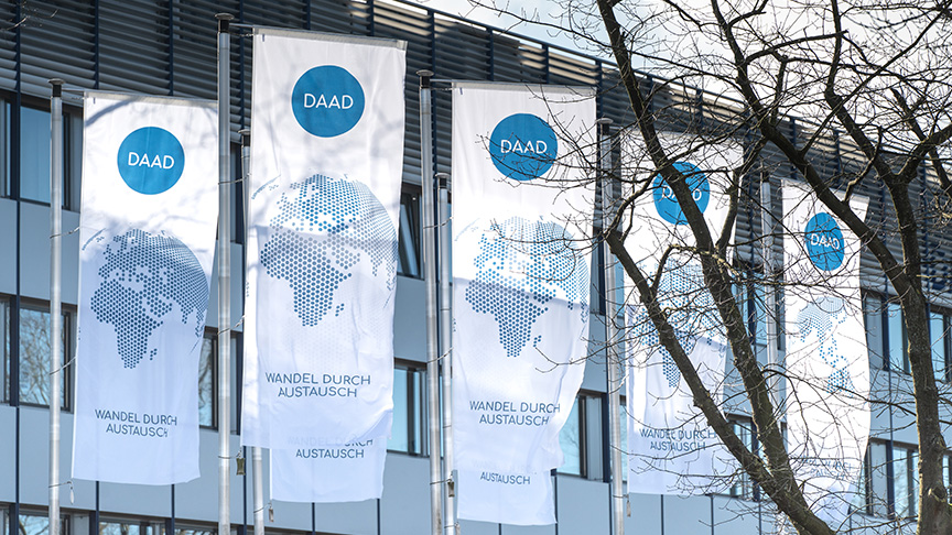 Fahnen mit dem DAAD-Logo vor der Außenfassade der Zentrale in Bonn.